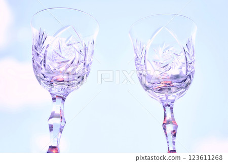 Drinking festive wine.Two shining crystal wine glasses on sky Drinking festive wine.Two shining crystal wine glasses on sky 123611268