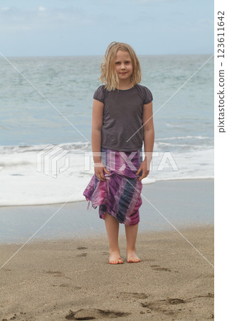 Cheerful child girl on the sea beach, outdoors portrait. Happy holiday Cheerful child girl on the sea beach, outdoors portrait. Happy holiday 123611642