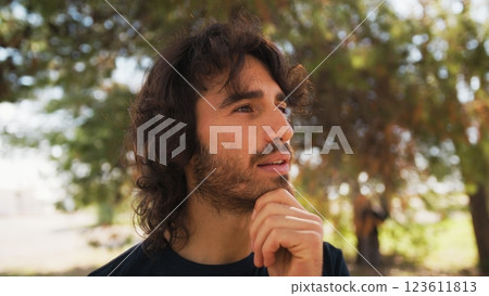 Long Hair Italian Man Reflects On The Text Of A Poster In The City Park 123611813