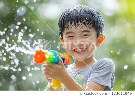 Asian boy playing with water gun on summer day 123611949