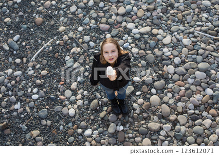 Top view of young girl with vanilla ice cream outdoors Top view of young girl with vanilla ice cream outdoors 123612071