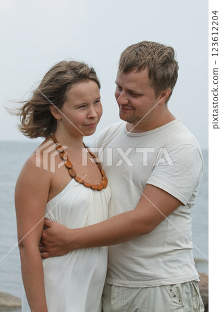 Man and woman hugging near sea, outdoors portrait 123612204