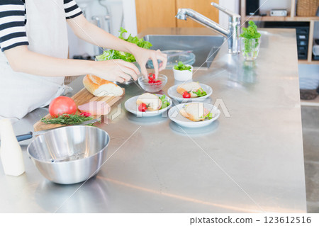 Young woman standing in the kitchen 123612516