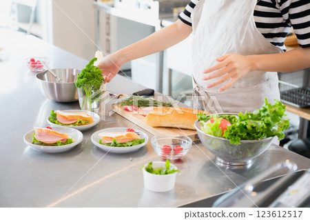 Young woman standing in the kitchen 123612517