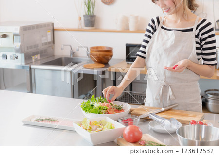 Young woman standing in the kitchen 123612532
