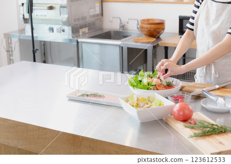 Young woman standing in the kitchen Young woman standing in the kitchen 123612533