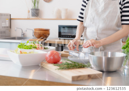Young woman standing in the kitchen Young woman standing in the kitchen 123612535