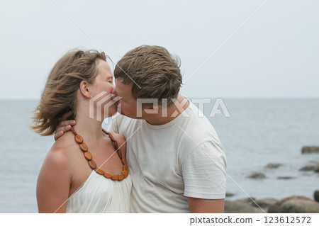 Kissing couple. Man and woman in love near sea outdoors Kissing couple. Man and woman in love near sea outdoors 123612572