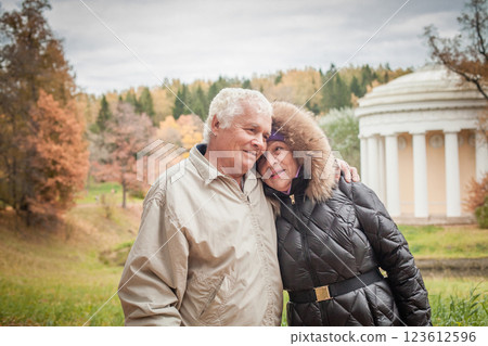 Elderly couple in autumn park portrait Elderly couple in autumn park portrait 123612596