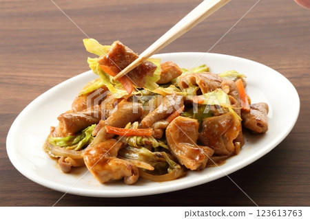 Eating stir-fried horumon with chopsticks Eating stir-fried horumon with chopsticks 123613763