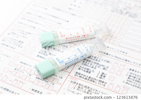 Medical questionnaire and stool test kit on white background Medical questionnaire and stool test kit on white background 123613876