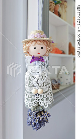Whimsical doll suspended with lavender bunch channels romantic aura, romantic vibe resonating in delicate craftsmanship, romantic undertone infusing interior with poetic charm throughout 123613888