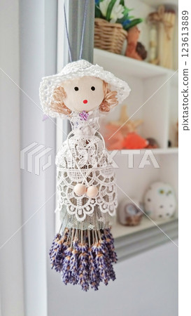 Charming decorative figure embraces calming lavandula essence, lavandula bouquet forming dainty skirt, lavandula aroma infusing gentle space, inspiring nature-focused home style 123613889