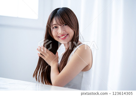 Young woman combing her hair with a hand comb 123614305