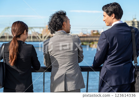 Three businessmen talking side by side Three businessmen talking side by side 123614336