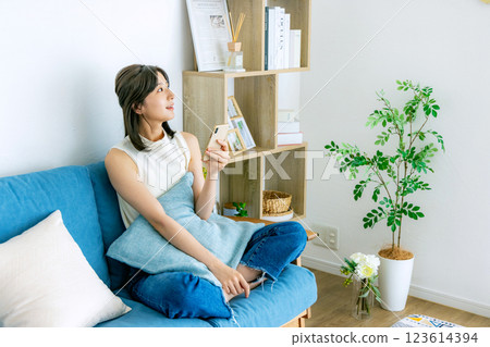 A smiling woman looking at a smartphone 123614394