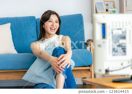 Woman relaxing in her room watching TV 123614415