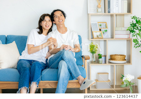 A young couple relaxing in the living room A young couple relaxing in the living room 123614437