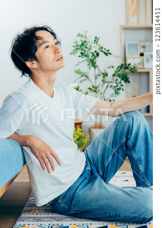 Young man relaxing in the living room Young man relaxing in the living room 123614451