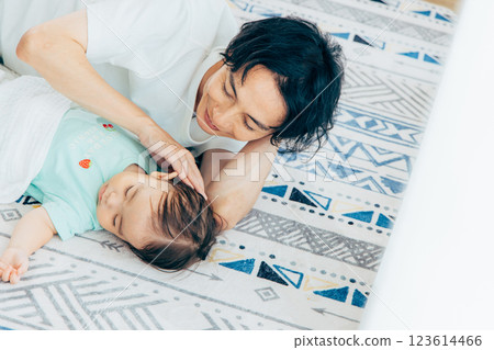 Baby and father lying down Baby and father lying down 123614466
