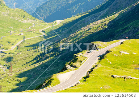 transfagarasan road winding uphill. beautiful scenery. travel destination in romania mountain landscape. sunny day in summer. view in to the valley. dangerous route 123614508