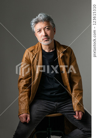 Handsome man sitting on chair Handsome man sitting on chair 123615310