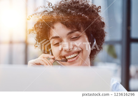 girl in a modern office working in a call center smiling 123616296