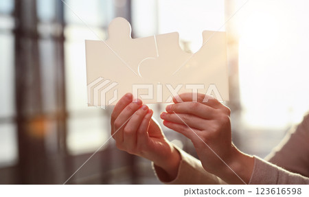 Business Woman holding two blank white puzzle pieces in his hands conceptual of solving a problem, growth and development. Business Woman holding two blank white puzzle pieces in his hands conceptual of solving a problem, growth and development. 123616598