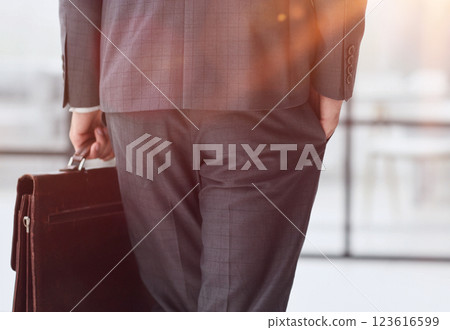 business man with briefcase in office back view 123616599