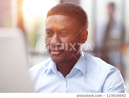 Thoughtful serious african man sit with laptop thinking of project 123616692