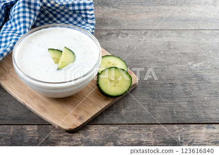 Greek Tzatziki sauce in bowl on wooden table Greek Tzatziki sauce in bowl on wooden table 123616840