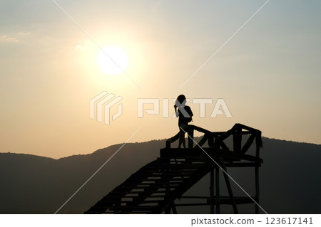 asian woman looking at water on beach Back side view of asian woman with beard, sitting in front of beautiful sea view, relaxing at beach alone with sunny. asian woman looking at water on beach Back side view of asian woman with beard, sitting in front of beautiful sea view, relaxing at beach alone with sunny. 123617141
