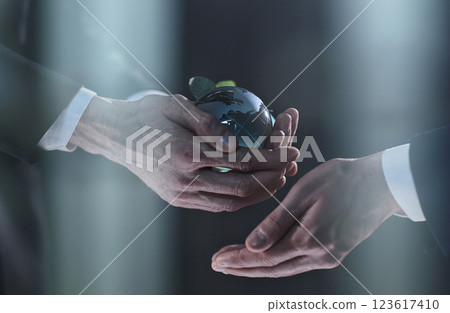 mock-up of the world in hands with a man on a black background 123617410