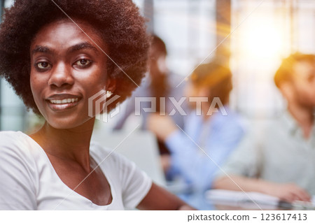 business woman with her staff in background at office business woman with her staff in background at office 123617413
