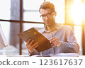 Close Up Of Businessman Taking Folders From Hand 123617637