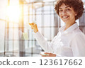 woman working on project plan using sticky papers notes on glass 123617662