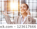 attractive woman talking on mobile phone while relaxing in office 123617666