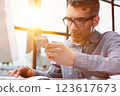Casual desktop of an entrepreneur sitting at work in the office 123617673