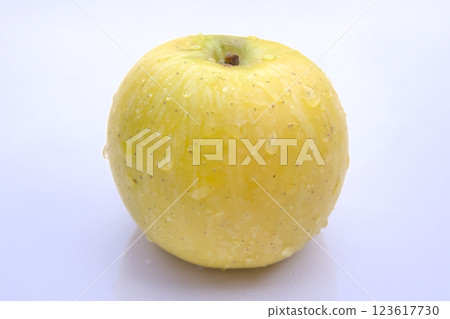 Fresh Golden Delicious Apple with Water Droplets, Close-Up Isolated on White Background Fresh Golden Delicious Apple with Water Droplets, Close-Up Isolated on White Background 123617730