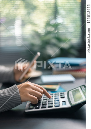 Finance bank tax expense accounting budget money businessman hand use calculator Financial calculate accountant close up calculator with graph chart write office desk Business expense analysis saving Finance bank tax expense accounting budget money businessman hand use calculator Financial calculate accountant close up calculator with graph chart write office desk Business expense analysis saving 123618453