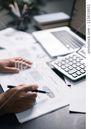 Finance bank tax expense accounting budget money businessman hand use calculator Financial calculate accountant close up calculator with graph chart write office desk Business expense analysis saving 123618951