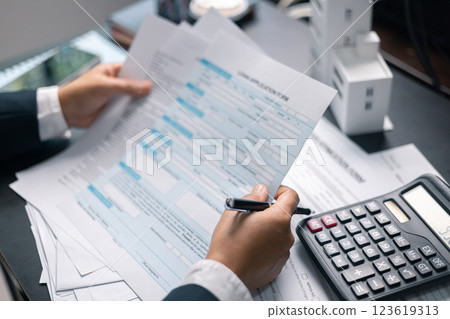 Finance bank tax expense accounting budget money businessman home for Business expense analysis saving use Financial calculate accountant close up calculator with graph chart hand write office desk 123619313