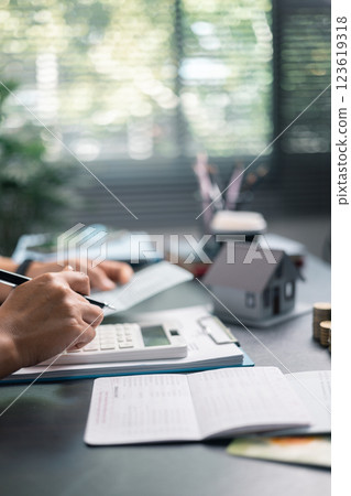 Finance bank tax expense accounting budget money businessman home for Business expense analysis saving use Financial calculate accountant close up calculator with graph chart hand write office desk 123619318