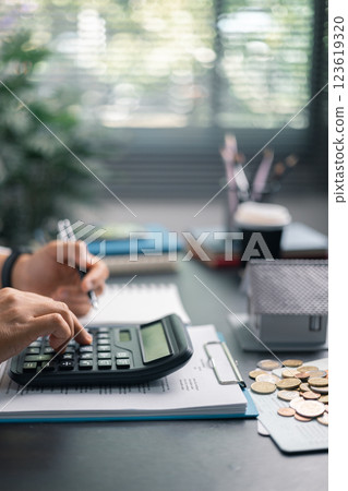 Finance bank tax expense accounting budget money businessman home for Business expense analysis saving use Financial calculate accountant close up calculator with graph chart hand write office desk 123619320