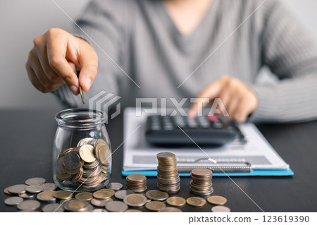 Finance bank tax expense accounting budget money businessman hand use calculator Financial calculate accountant close up calculator with graph chart write office desk Business expense analysis saving 123619390