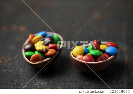 Easter chocolate egg with colorful dragees 123619653