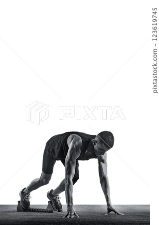 Young athletic man, sportsman, sprinter standing on starting line ready to run against white background. Monochrome photo. Young athletic man, sportsman, sprinter standing on starting line ready to run against white background. Monochrome photo. 123619745