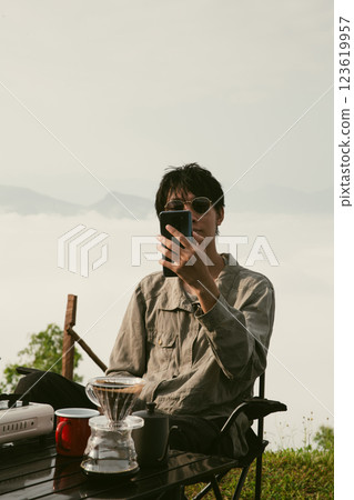 Young business man working computer on peak hill. Hiker online shopping on laptop at sunset, sunrise on top mountain, freelance person remote work with digital tablet. travel vacation holiday concept 123619957