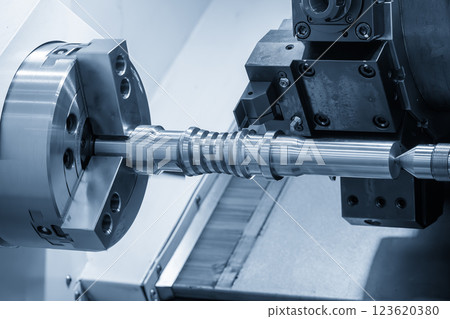 The  CNC lathe machine forming  cutting the metal screw shaft parts in the light blue scene. 123620380