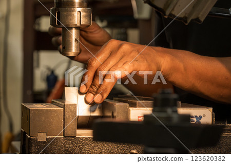 The metal working operation on NC milling machine. 123620382